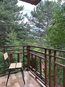 a wooden balcony with a bench and trees at Sochiner Hotel in Vanadzor