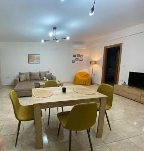 a living room with a table and chairs and a couch at Maria’s Apartment in Monemvasia