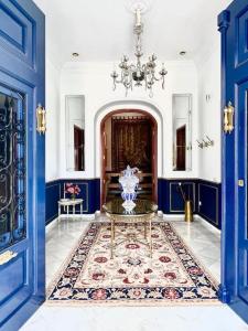 a blue and white room with a table and blue doors at Villa Paula Valencia in Manises