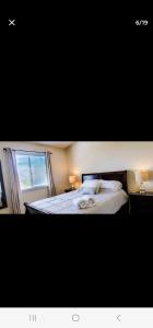 a bedroom with a bed with two lamps and a window at Mallard in Jacksonville +2 photos