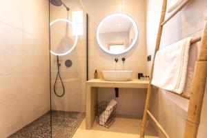 a bathroom with a sink and a mirror at Portogal Apartments in Argostoli
