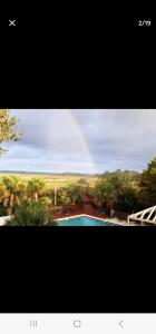 a rainbow in the sky over a swimming pool at Mallard in Jacksonville