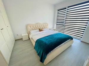 - une chambre avec un grand lit et une grande fenêtre dans l'établissement YamaLuxe Apartments - Citadel Residence, à Cluj-Napoca