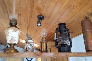 a group of lights hanging from a wooden ceiling at Sous le château in Montaut-de-Crieux