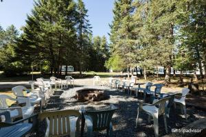 a row of white chairs around a fire pit at 3 Bedroom Pool PlayArea CampFire Cozy Apt in Bar Harbor