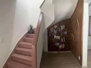 a staircase with bookshelves in a house at Casa helenico in Mexico City