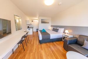 una habitación de hotel con una cama y un sofá en Eden Motel, en Eden