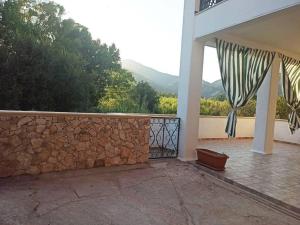a balcony of a house with a stone wall at Casa Vacanze Gio&le in Domusnovas