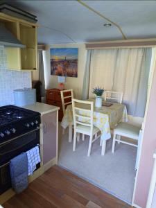 a kitchen with a table and chairs and a dining room at Snowdon Retreat in Llanrug