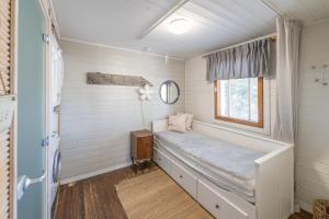 a small room with a bed and a window at Villa Einola- modern rivercottage with jacuzzi in Pori