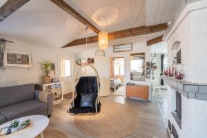 a living room with a couch and a table at Villa Einola- modern rivercottage with jacuzzi in Pori