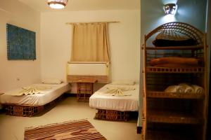 A bed or beds in a room at Habiba Beach Lodge