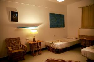 A bed or beds in a room at Habiba Beach Lodge