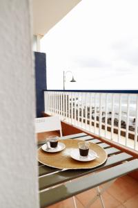 two cups of coffee on a table on a balcony at Apartamento Maye in Bajamar