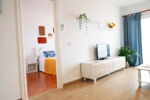 a room with a bedroom with a bed and a mirror at Apartamento Maye in Bajamar +12 photos