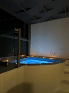 a swimming pool in the middle of a building at night at Tristhenia in Perissa