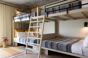 a bunk bed room with two beds and two twin beds at Moxy Charleston Downtown in Charleston