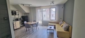 a small living room with a couch and a table at Дунав Билдингс 2 in Pleven
