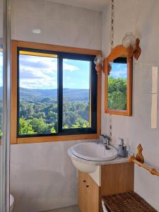 uma casa de banho com um lavatório e uma janela em Ás Portas do Sil - En la Ribeira Sacra 