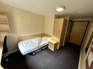 Kleines Zimmer mit einem Bett und einem Schrank in der Unterkunft Spacious Ensuite Room With Shared Kitchen and Living Room in Crewe