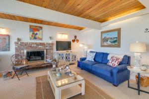 a living room with a blue couch and a fireplace at West Beach Retreat in Oak Harbor