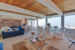 a living room with a blue couch and a table at West Beach Retreat in Oak Harbor