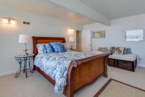 a bedroom with a large bed with blue pillows at West Beach Retreat in Oak Harbor