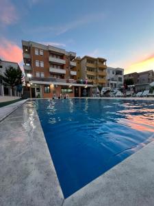 a large swimming pool in front of a building at Apartments Edona in Ulcinj
