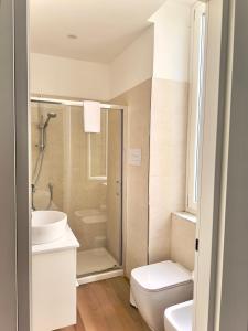 a bathroom with a shower and a toilet and a sink at B&B Cellini in Santa Maria di Castellabate