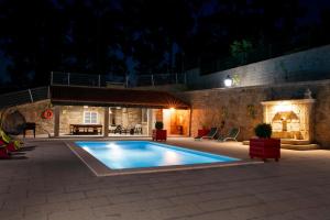 a swimming pool in a yard at night at Casa do Sabugueiro in Ponte de Lima