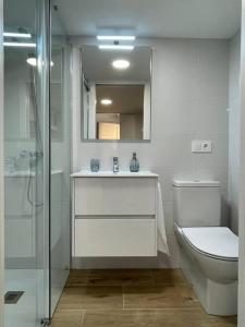 a bathroom with a toilet and a sink and a shower at MiniLoft #Baiona / in Baiona