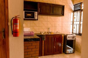 a kitchen with a fire hydrant in the corner at B I G Residence Hotel in Bujumbura