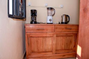 a wooden dresser with a blender on top of it at B I G Residence Hotel in Bujumbura