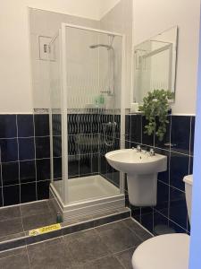 a bathroom with a shower and a sink at Martello Hotel in Hull