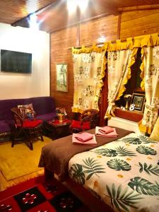 a bedroom with a bed and a living room at Villa Miris Dunja in Zlatibor