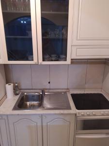 a kitchen with white cabinets and a sink at Apartman Nina in Banja Luka