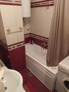 a bathroom with a tub and a toilet and a sink at Apartman Nina in Banja Luka