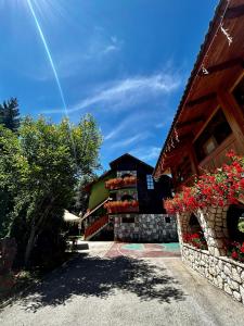 a building with flowers on the side of it at Villa Miris Dunja in Zlatibor