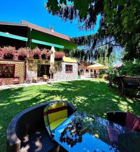 a backyard with a swimming pool in the grass at Villa Miris Dunja in Zlatibor