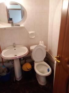 a bathroom with a sink and a toilet and a mirror at Studio in Craiova in Craiova