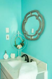 a bathroom with a sink and a mirror on the wall at Isle See You At the Beach in Emerald Isle