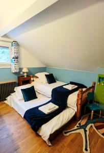 a bedroom with two beds and a chair at Comfortable House 100m2, 20 min from Paris with BBQ and private shared garden in Épinay-sur-Orge
