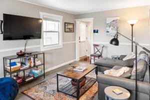 a living room with a couch and a tv at Stylish 2BR Mere Minutes from Skiing Main Street in Park City