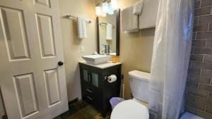 a bathroom with a white toilet and a sink at Stylish 2BR Mere Minutes from Skiing Main Street in Park City +17 photos
