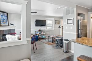 a kitchen and living room with white walls and a counter at Stylish 2BR Mere Minutes from Skiing Main Street in Park City