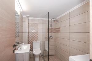 a bathroom with a shower and a toilet and a sink at Chistina’s brand new apartment in Kyparissia +24 photos