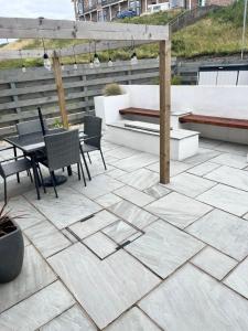 a patio with a table and chairs on a roof at Dolphin view in Spittal