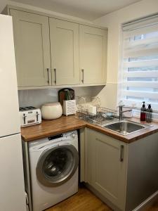 a kitchen with a washing machine and a sink at Dolphin view in Spittal