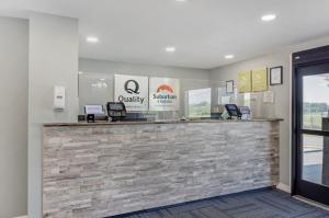 a lobby of a office with a stone counter at Suburban Studios Verona - Staunton North in Staunton +50 photos