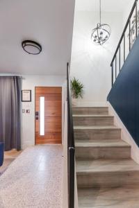 a hallway with stairs and a wooden door at VENICe Villa HOUSE! 8 minutes to STRIP -10 Freemont -7 Airport in Las Vegas